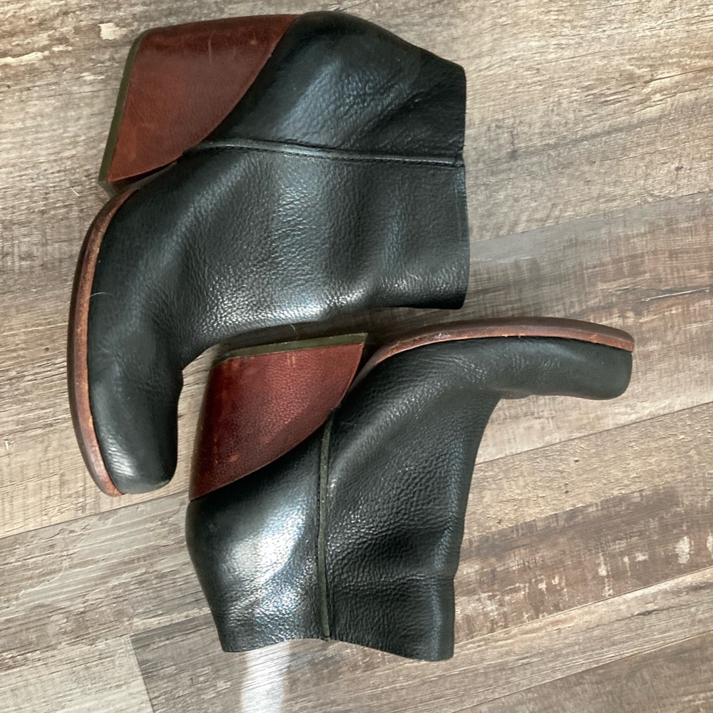 Korkease size 8 black leather bootie with a brown wedge.
